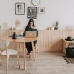 pensive woman using laptop at home